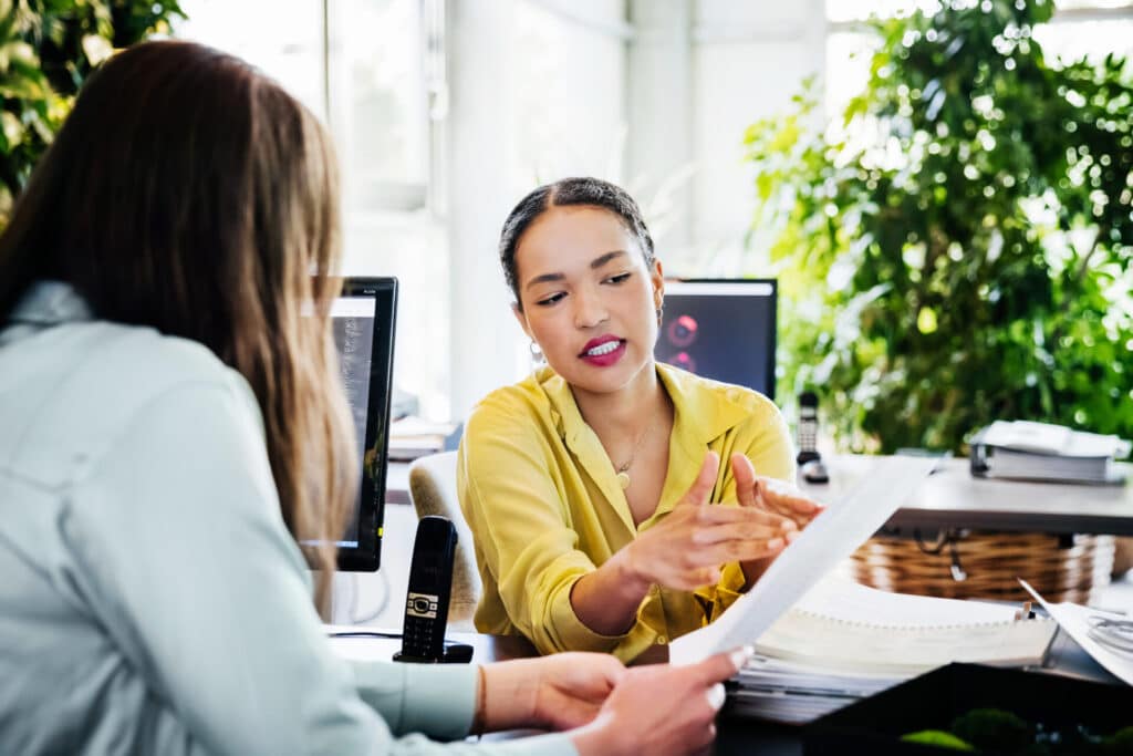 Two business women talking about a project.