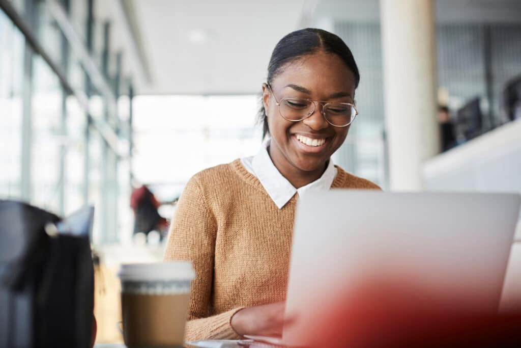 Smiling young business woman is learning a language at work.