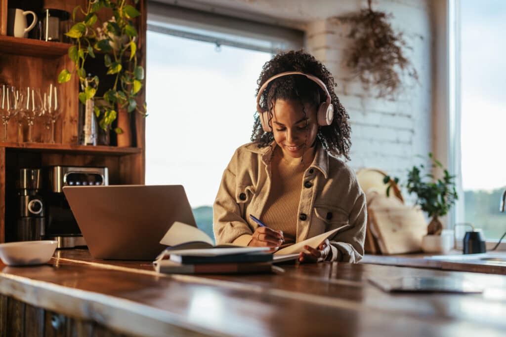 A woman finds joy in learning a language at home, thanks to her intrinsic motivation.