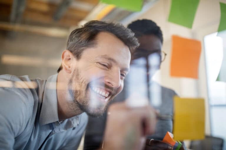 Young business people are smiling and talking freely with their Business English skills in a meeting.