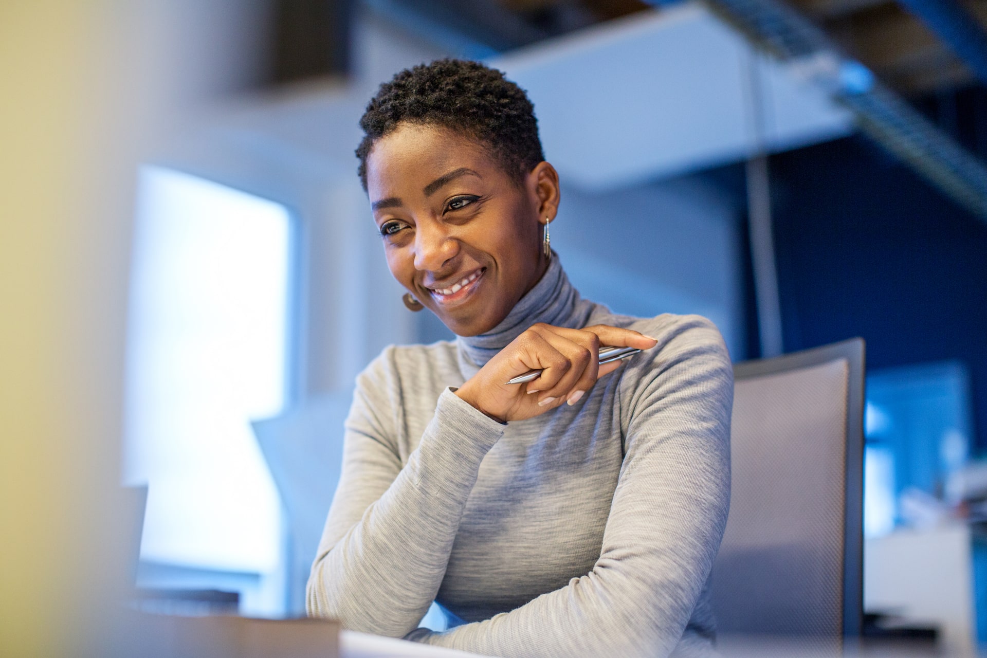 Smiling business woman using her corporate language training on her computer.