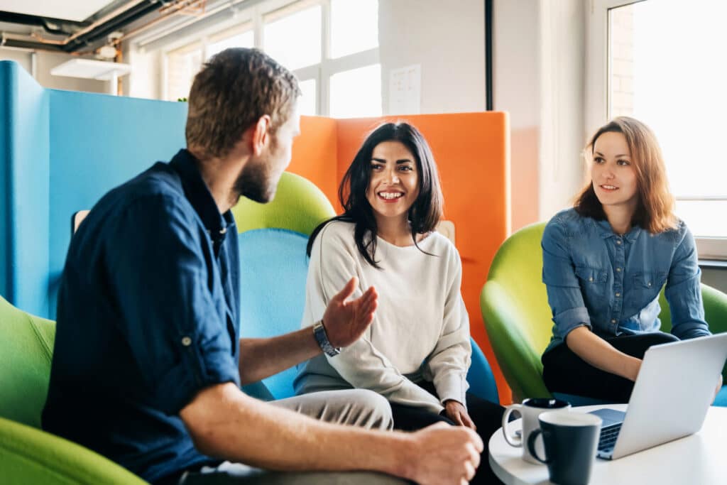 Young business people are talking in an office about organizational communication.