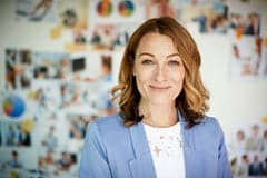 Smiling business woman standing in an office.