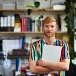 Employee holding a laptop working a modern company culture