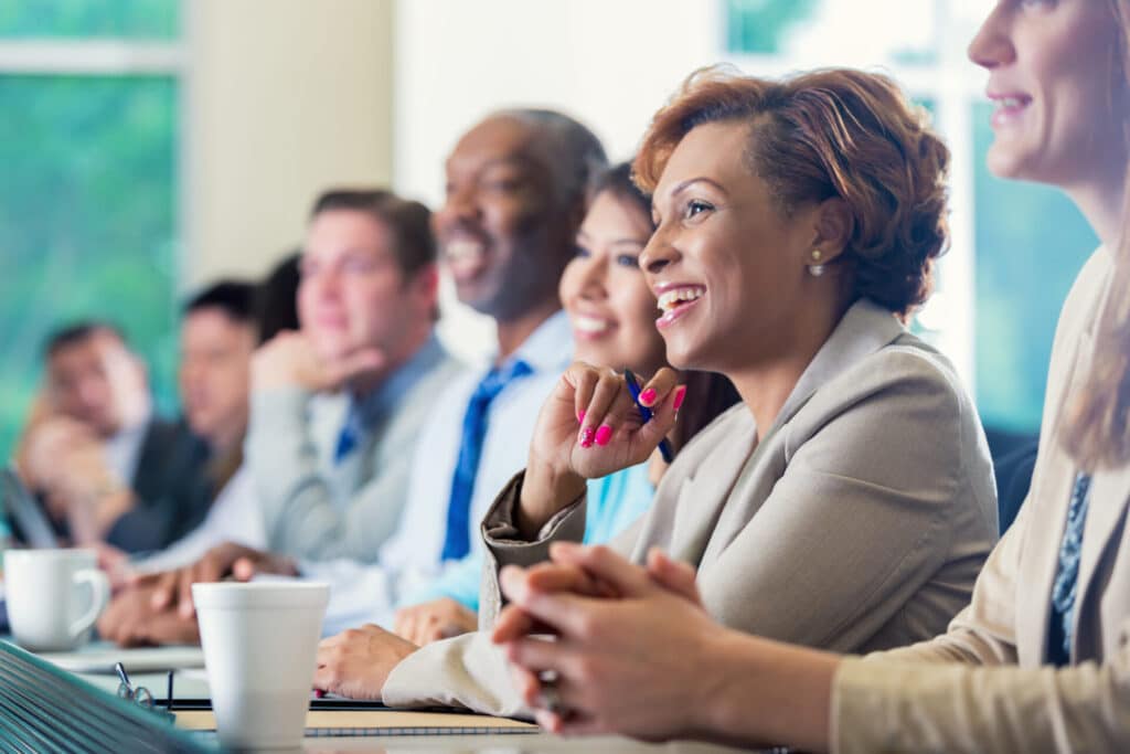 Happy employees who are learning in a course.