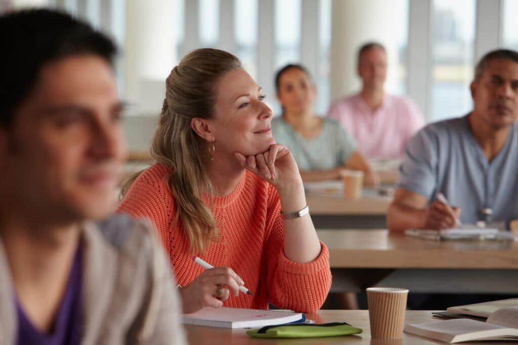 Happy employees who are learning in a course.