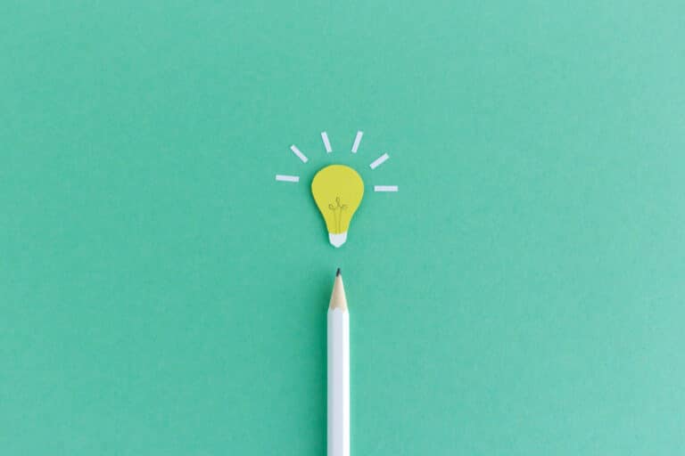 Collage of a pencil below a light bulb, as a symbol of finding the right mission statement.