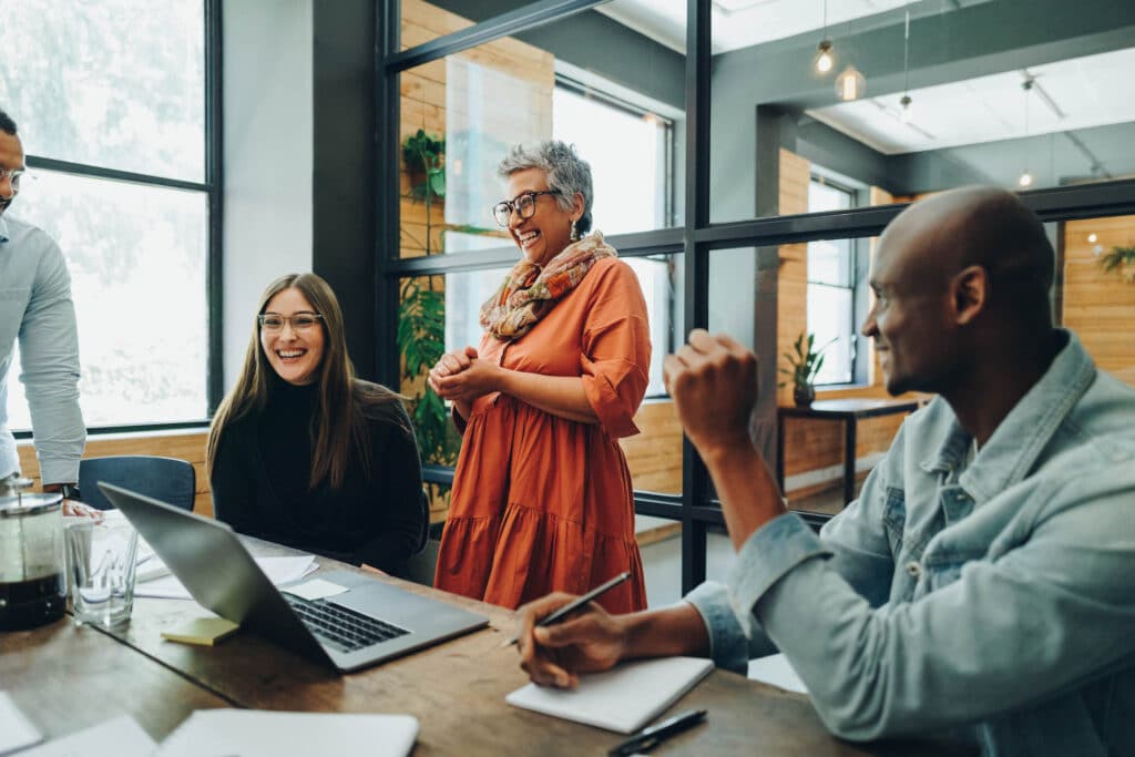 Business people are chatting and laughing in an office.