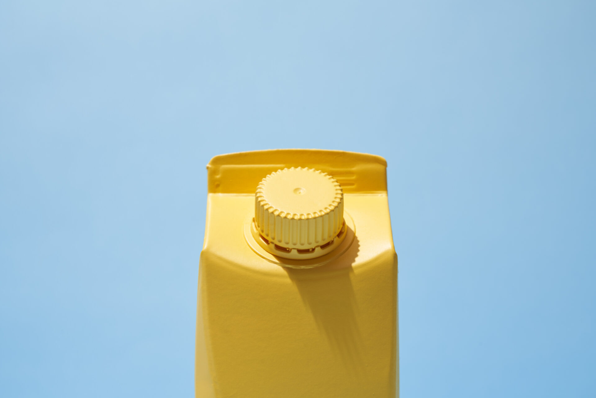 Yellow Small Milk Or Juice Box On Blue Background
