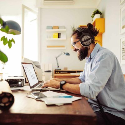 man smiling at laptop